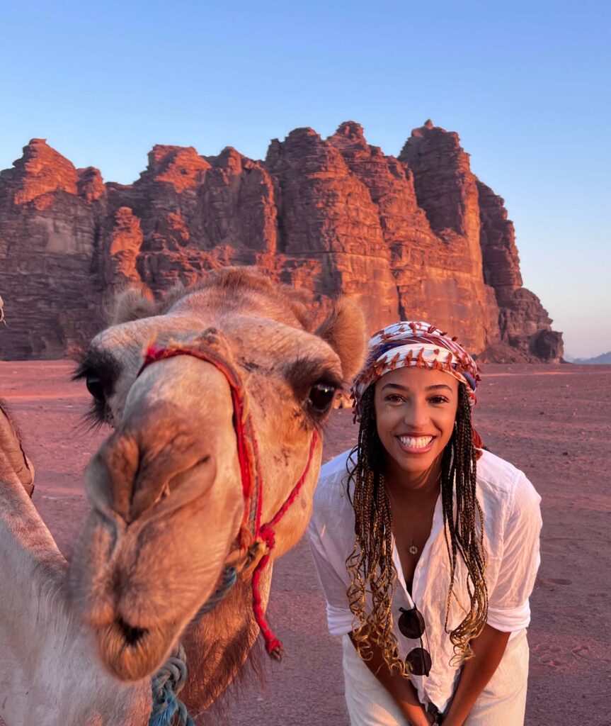wadi rum female traveler in the country Jordan with a camel at sunrise