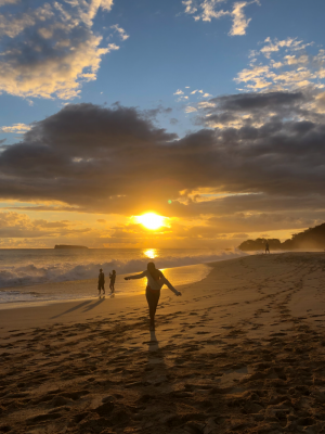 Girl walking on Makena Beach at sunset